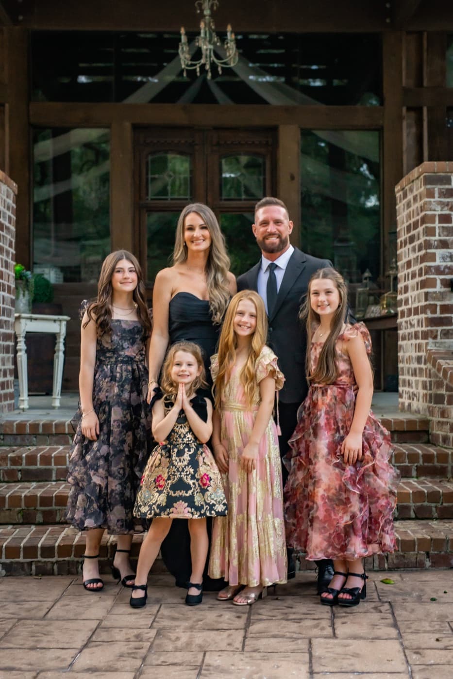Russell and Brittany Harris with their daughters on the front steps